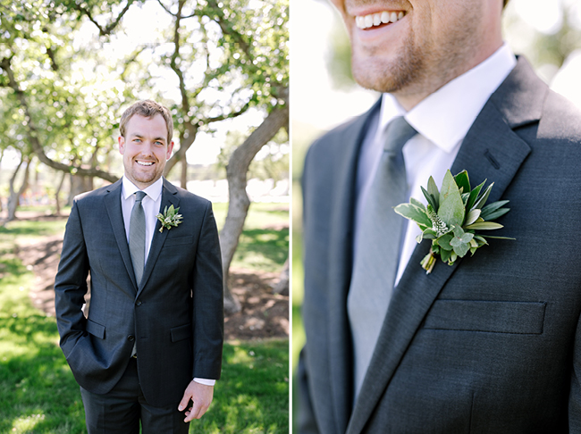 Groom pictures at Canyonwood Ridge, wearing a gray suit and an olive branch boutonniere 