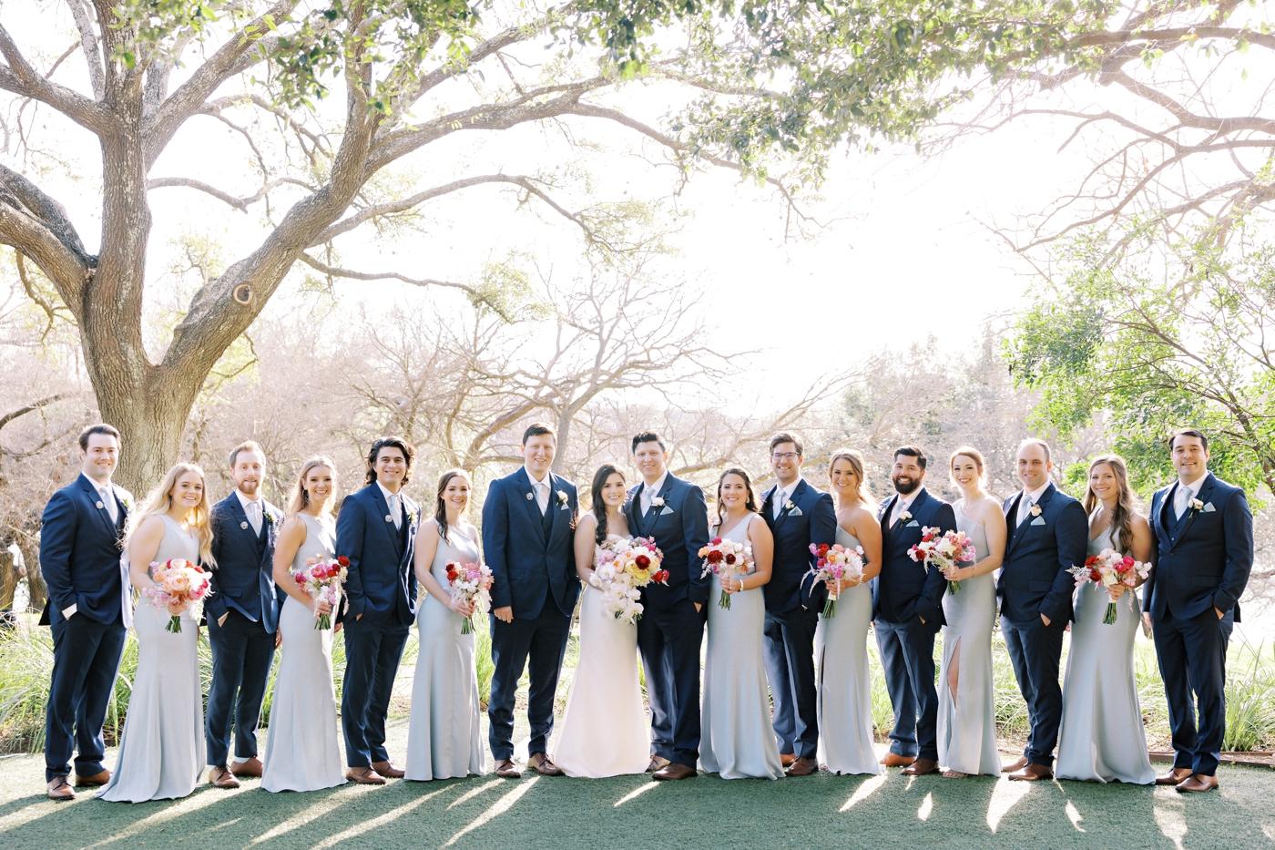 Dusty blue bridesmaids dresses and groomsmen in blue suits