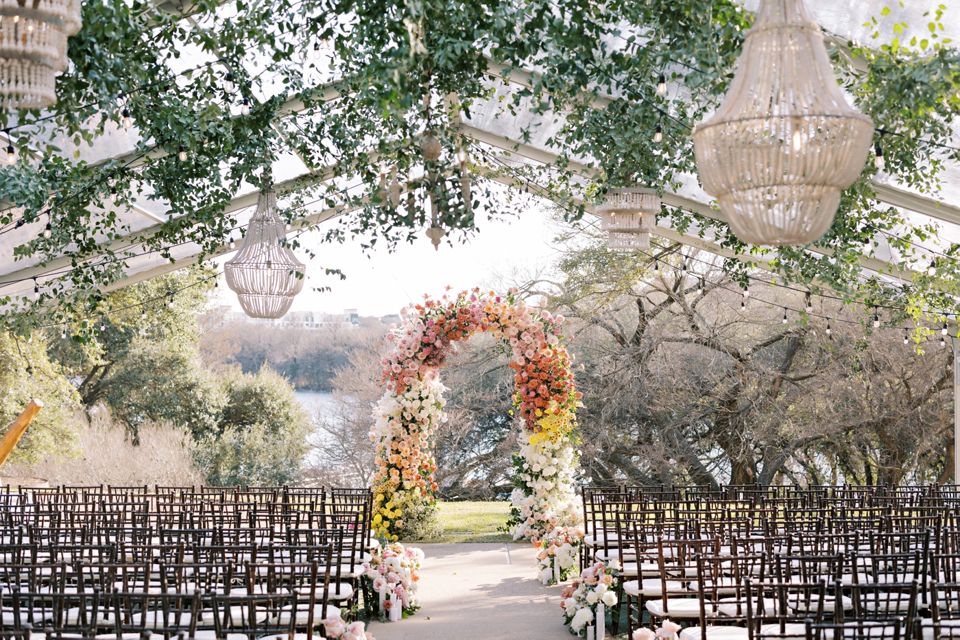 Colorful wedding ceremony arch by Posey Designs at The Four Seasons Austin