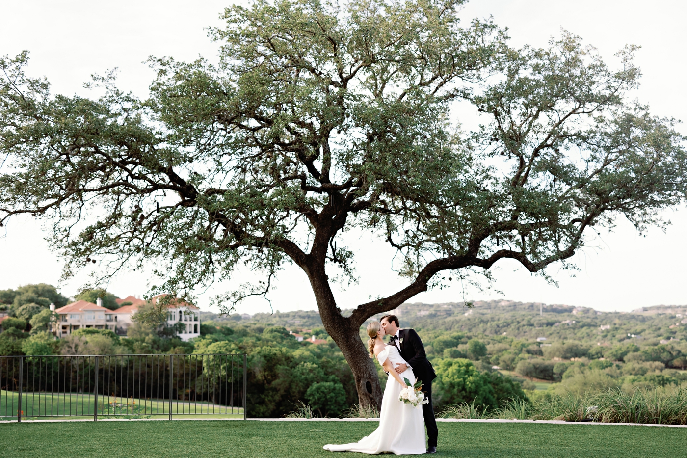 Golden hour bride and groom pictures on the lawn at Omni Barton Creek