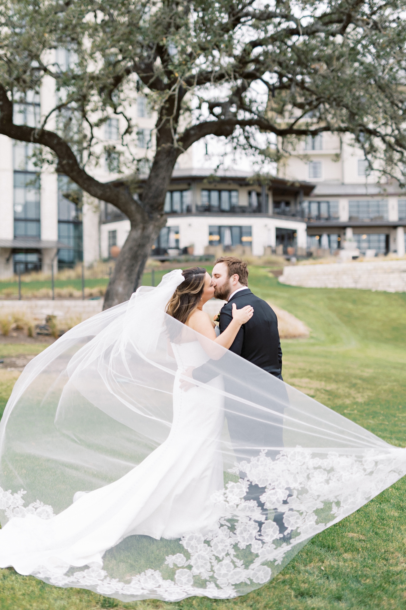 Bride and groom pictures on the lawn at Omni Barton Creek