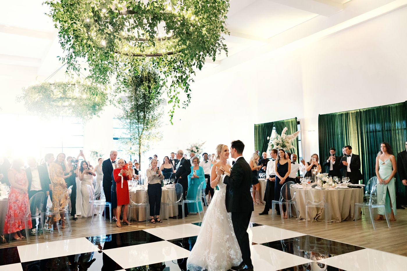 Bride and groom dancing on a checkered dance floor