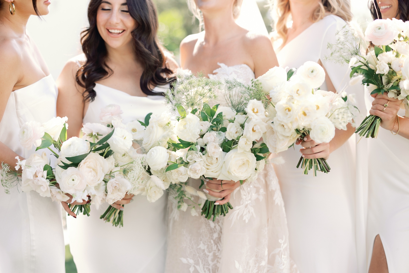 White bridal bouquets filled with roses, poppies, and Queen Anne's Lace by Stems Floral