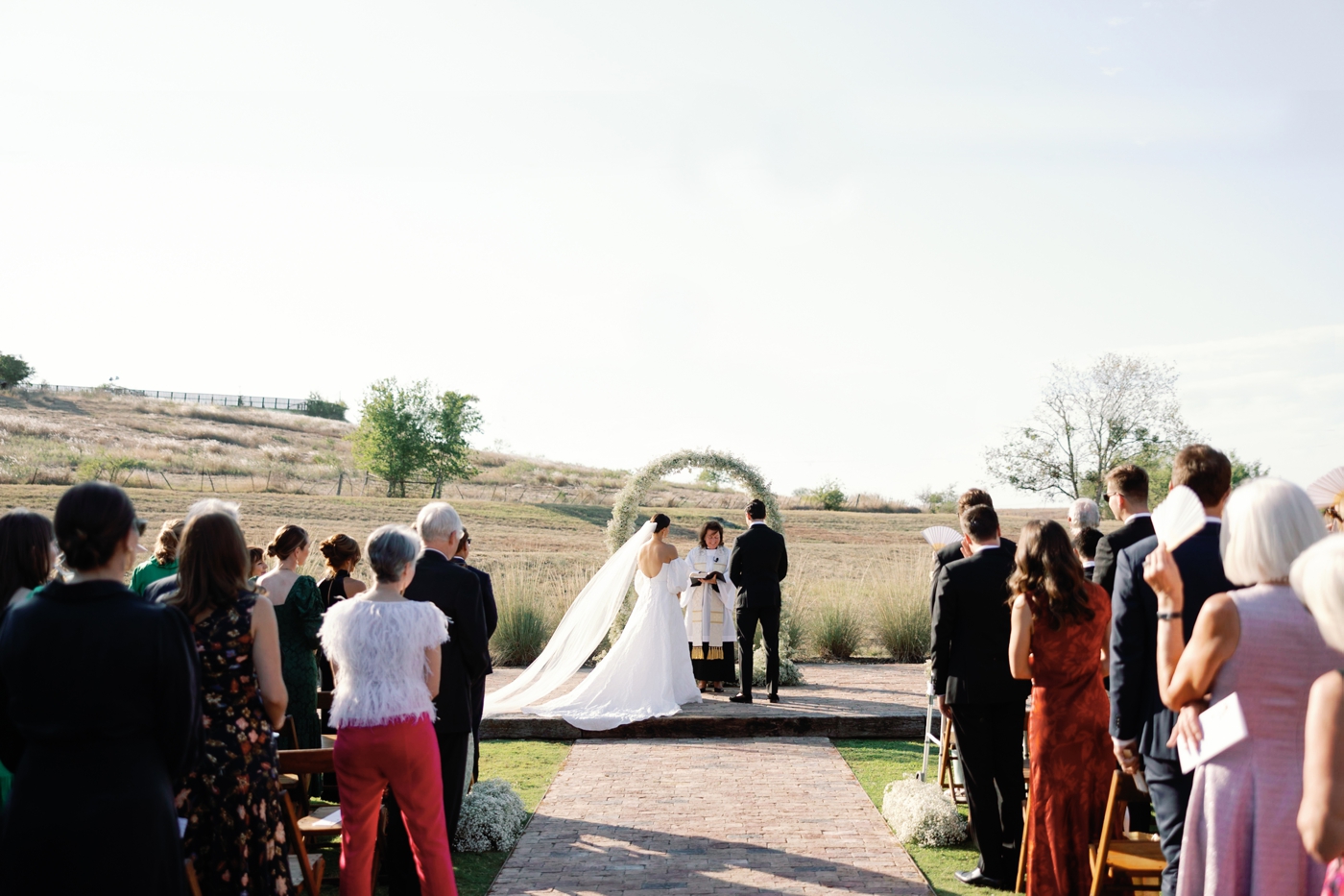 Outdoor ceremony at Two Wishes Ranch with a baby's breath covered ceremony arch