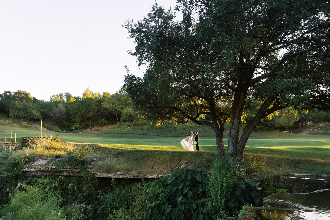 Bride and groom pictures on the golf course at sunset at Omni Barton Creek