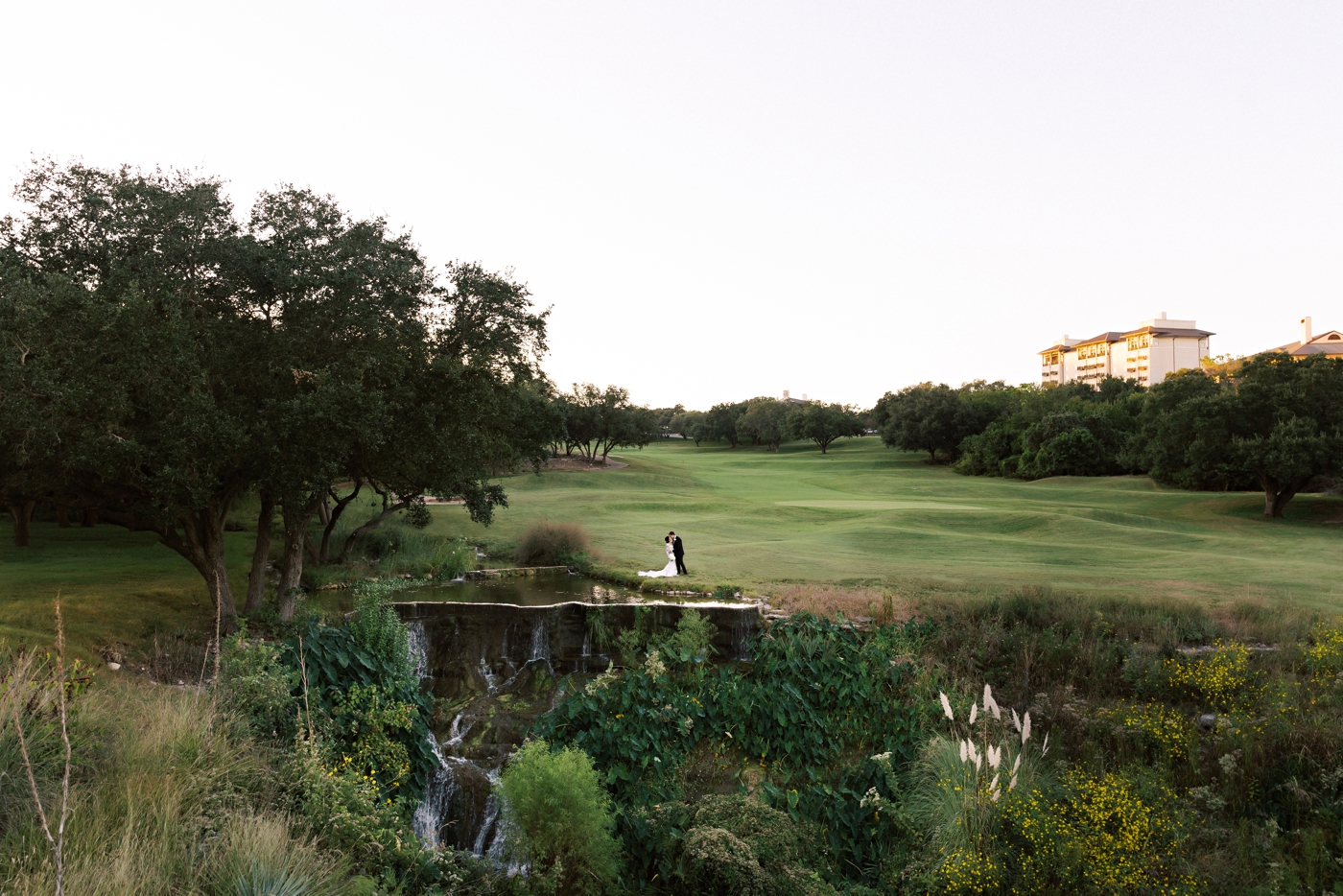 Bride and groom pictures on the golf course at sunset at Omni Barton Creek