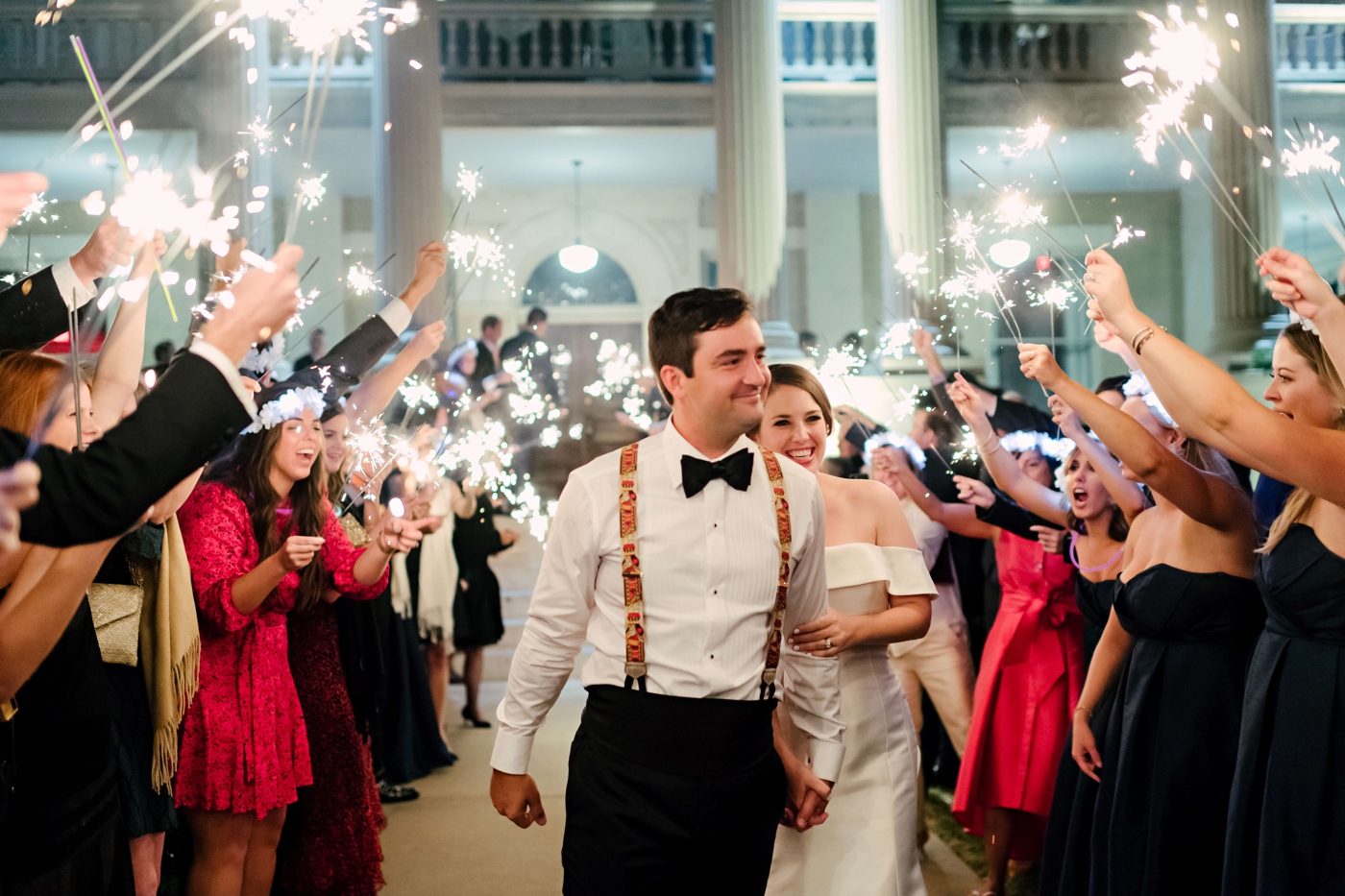 Bride and groom walking through a sparkler exit