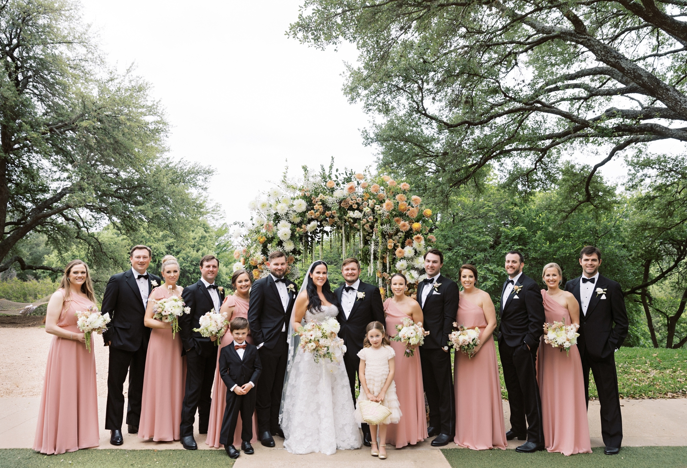 Blush wedding party with the men in black tuxedos in downtown Austin