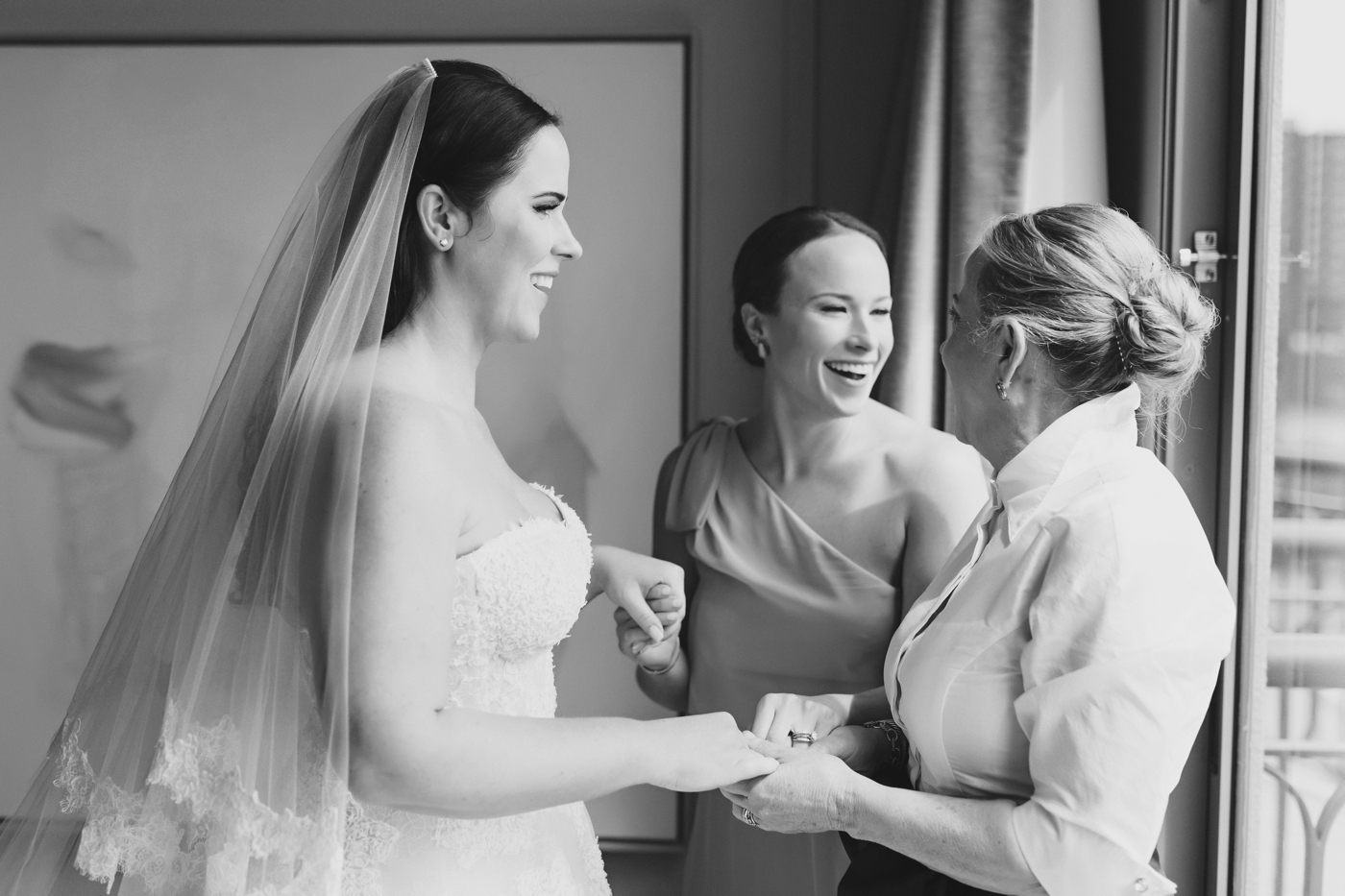 Bride holding her mothers hand as she gets ready for her Austin wedding 