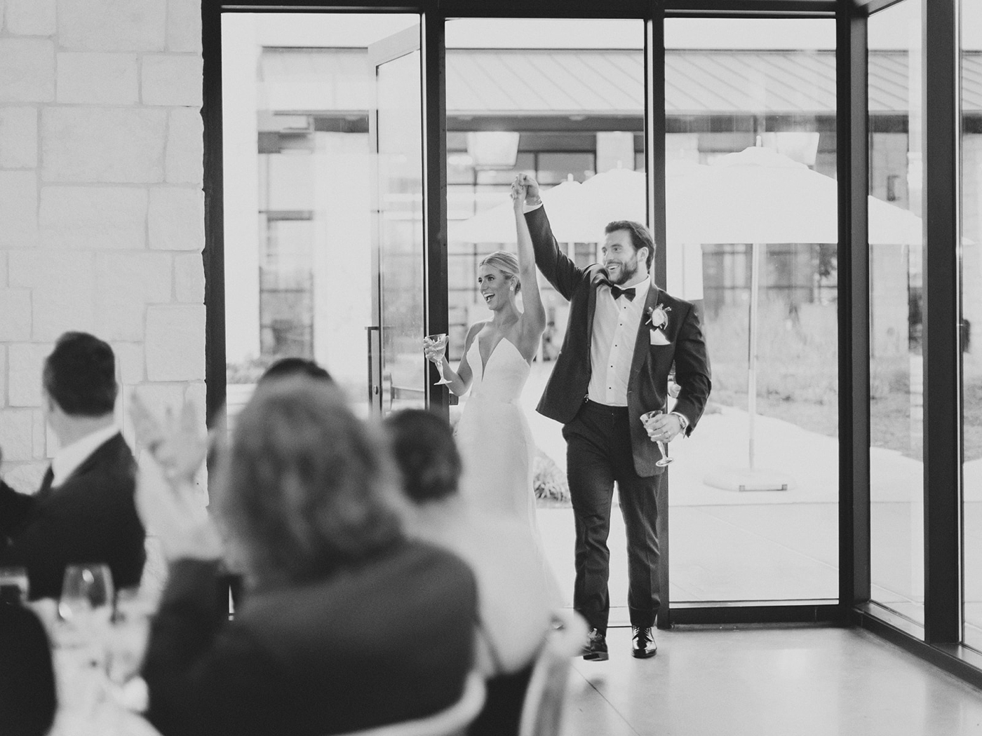 Bride and groom entering the reception hall at Omni Barton Creek, holding hands