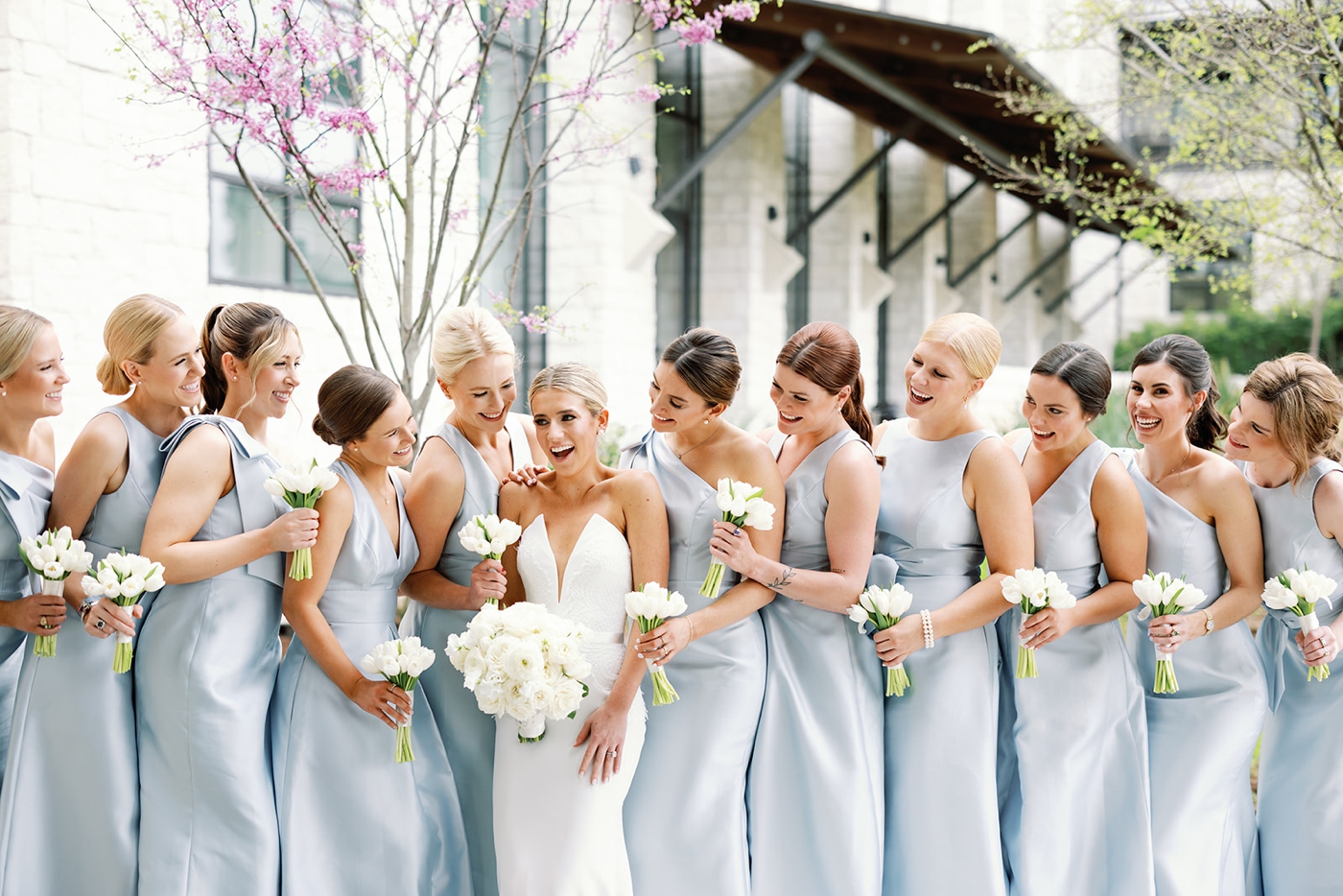 Bridesmaids in dusty blue satin dresses