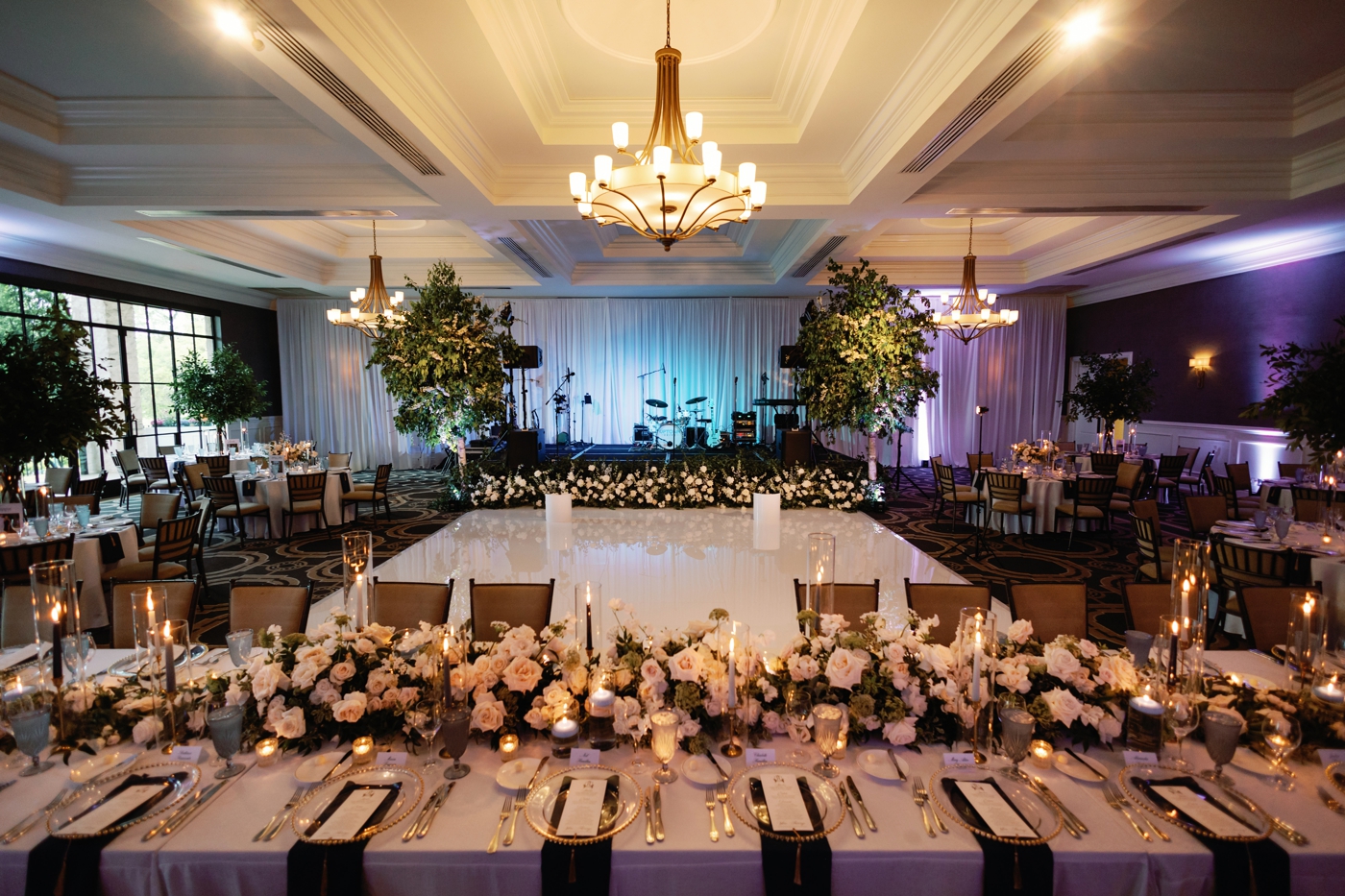 Wedding reception indoors at Austin Country Club, with round and long tables covered in candlelight