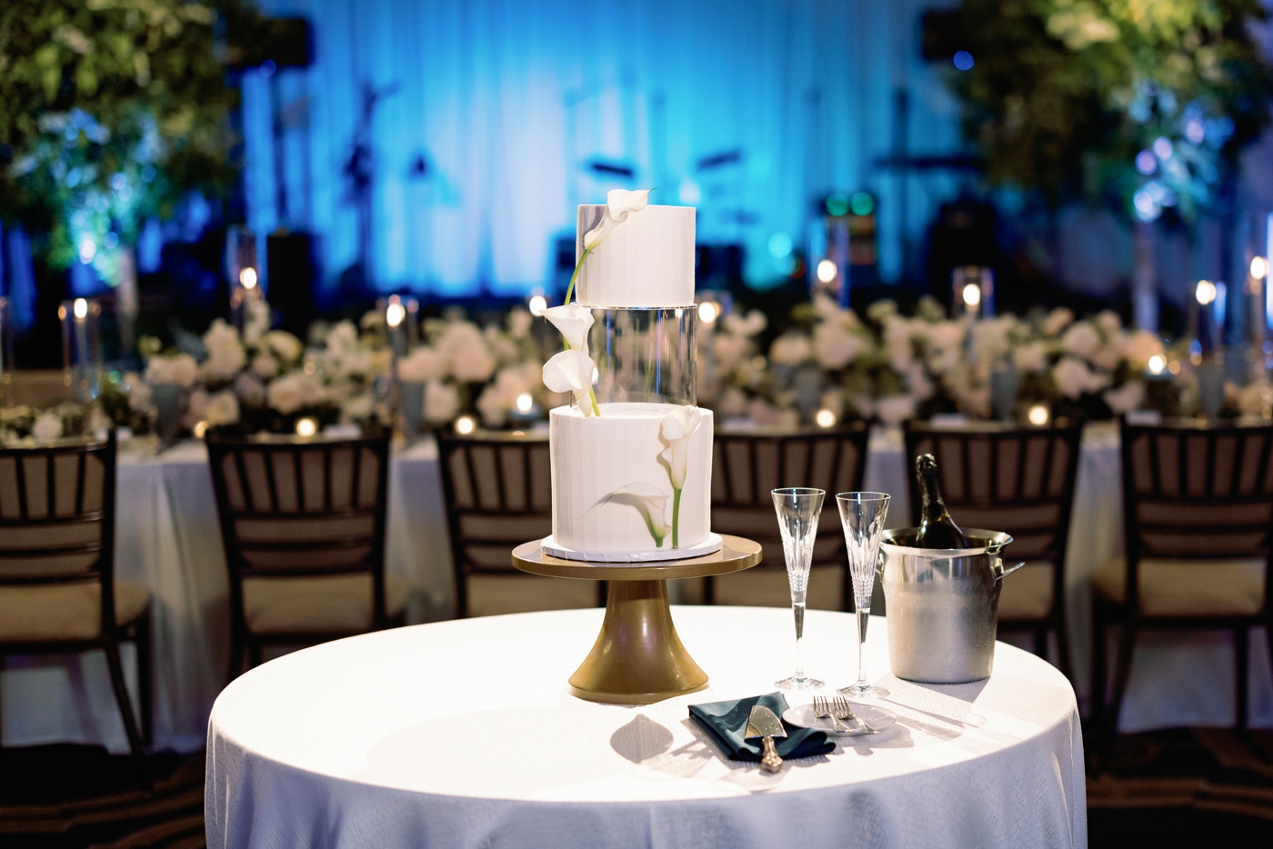 Three tier wedding cake, with the middle section a clear acrylic