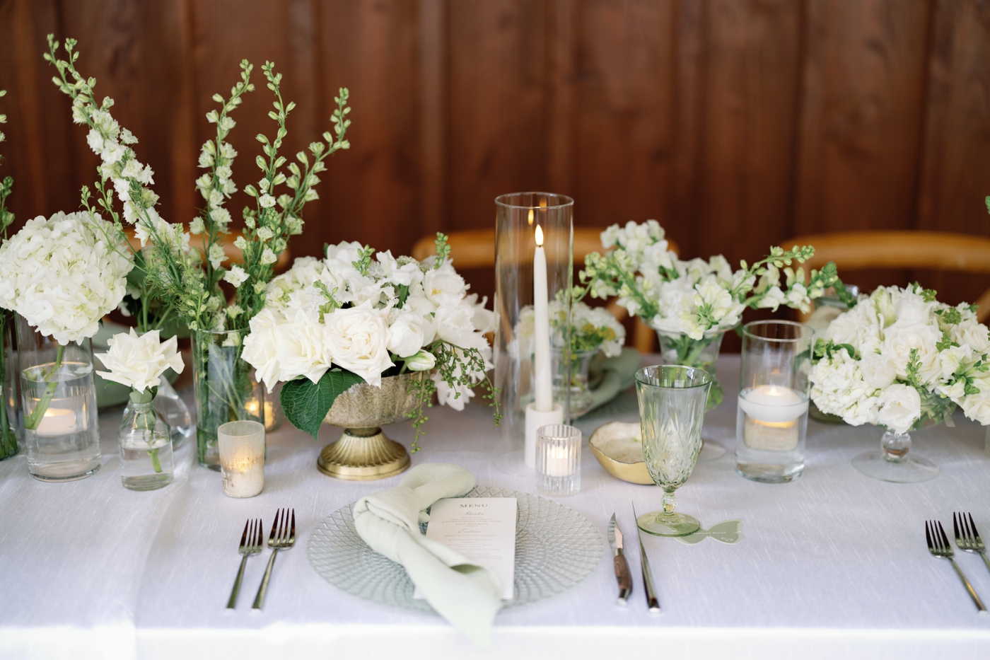 Table covered in fresh white flowers and candles