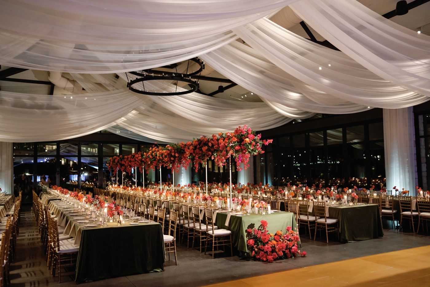 Dramatic floral arrangements with cascading Bougainvillea, garden roses, and lush greenery at a wedding reception at Omni Barton Creek