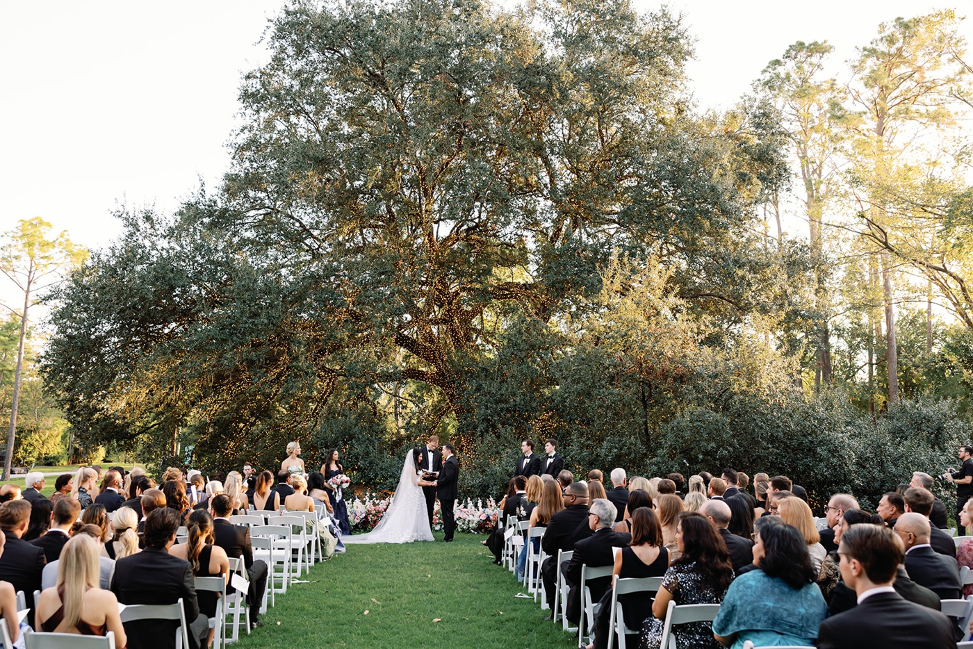 Bride and groom at Christian ceremony under Texas live oak tree at The Houstonian.