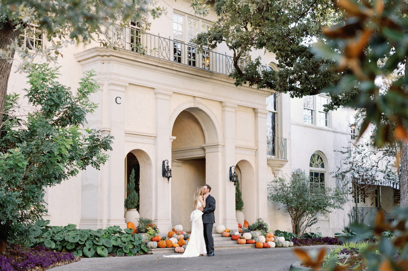 Couple in front of Commodore Perry Estate with a pumpkin covered porch for their engagement session