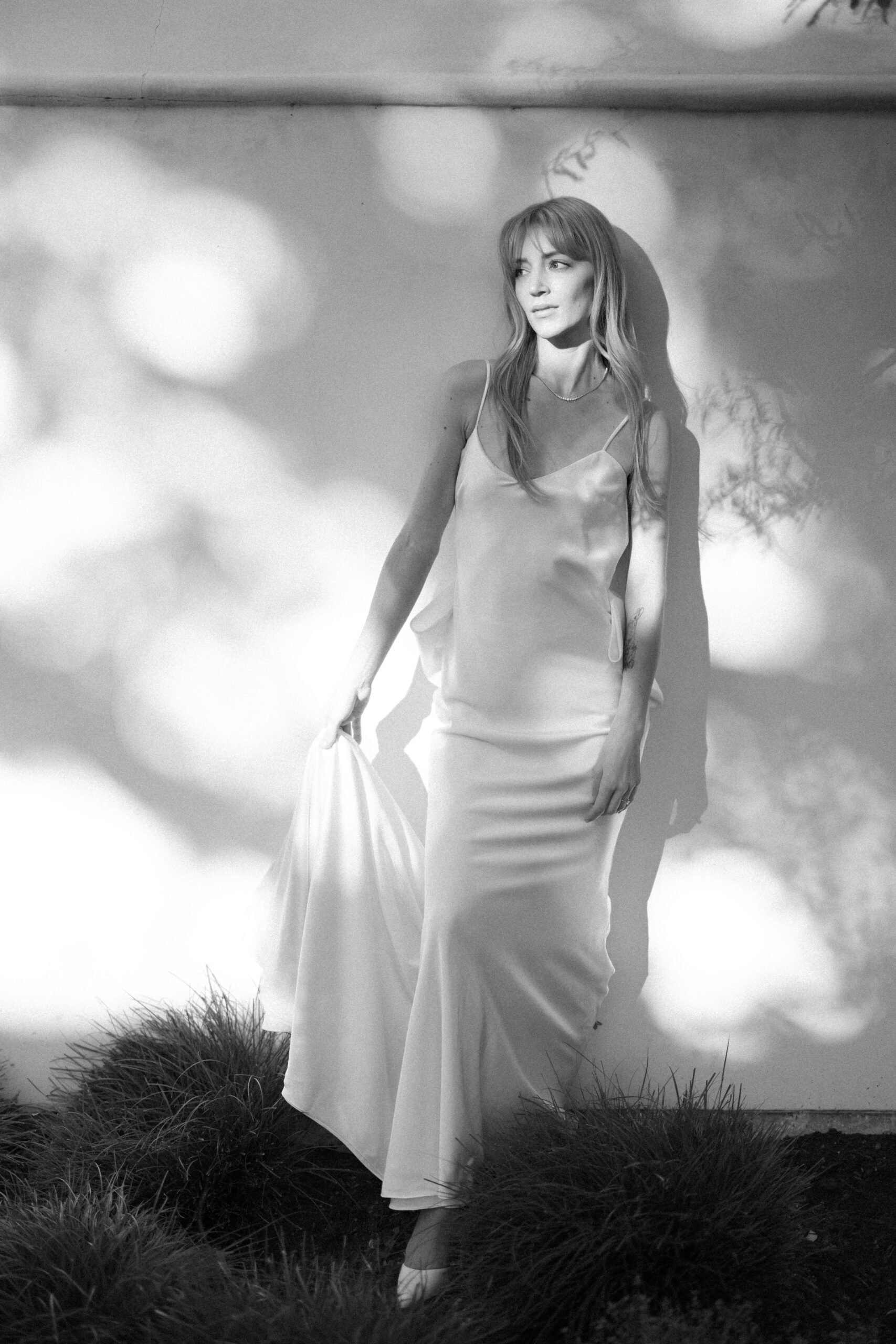 Downtown Austin engagement session in a garden, with the bride in a Halfpenny London Gown