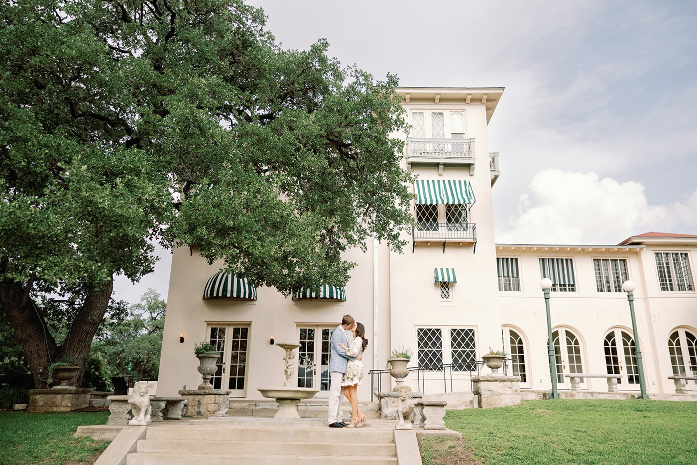 Engagement portraits at Laguna Gloria with Italian-style architecture and river views.
