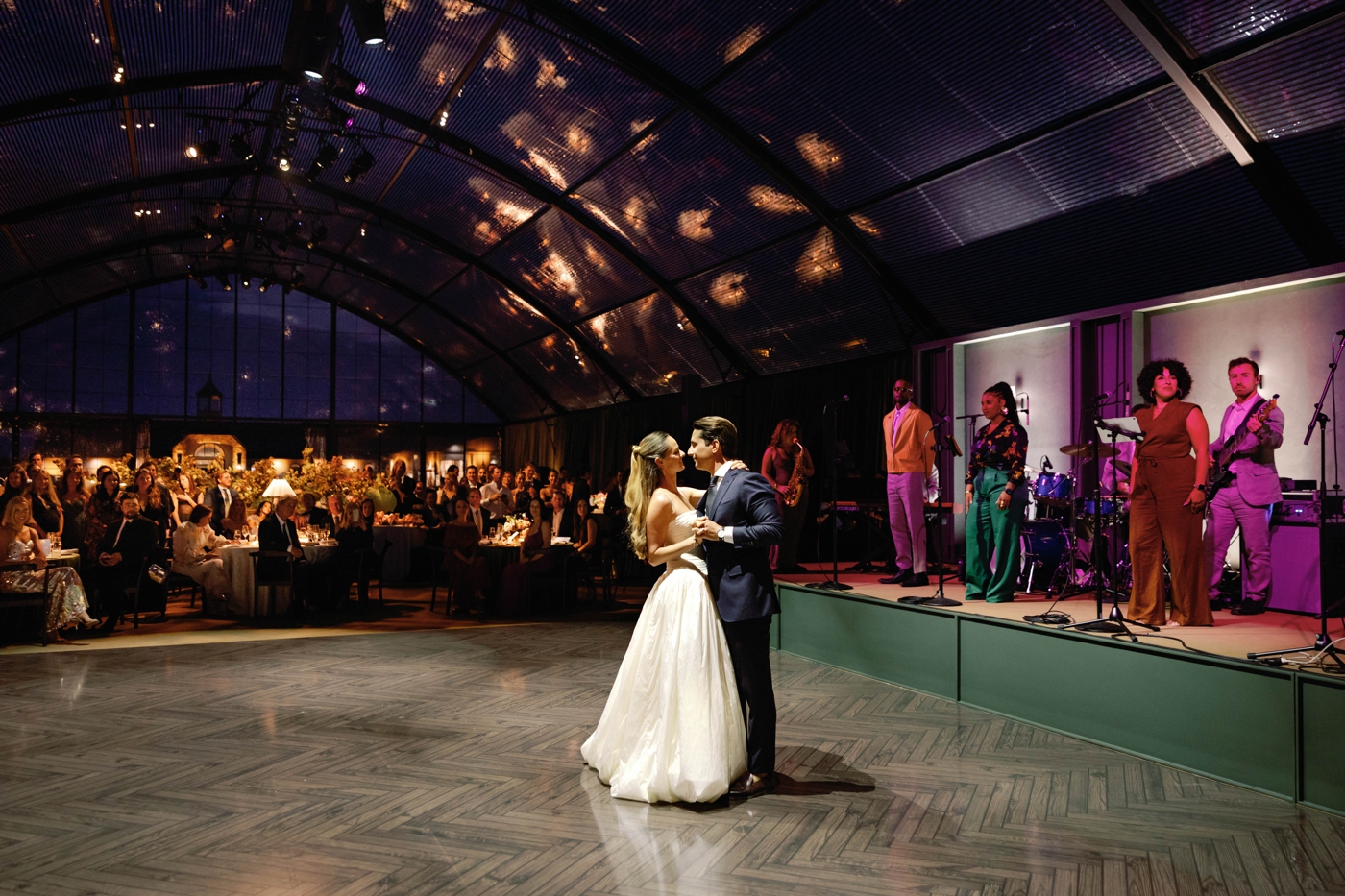Bride and groom first dance, with the band behind them