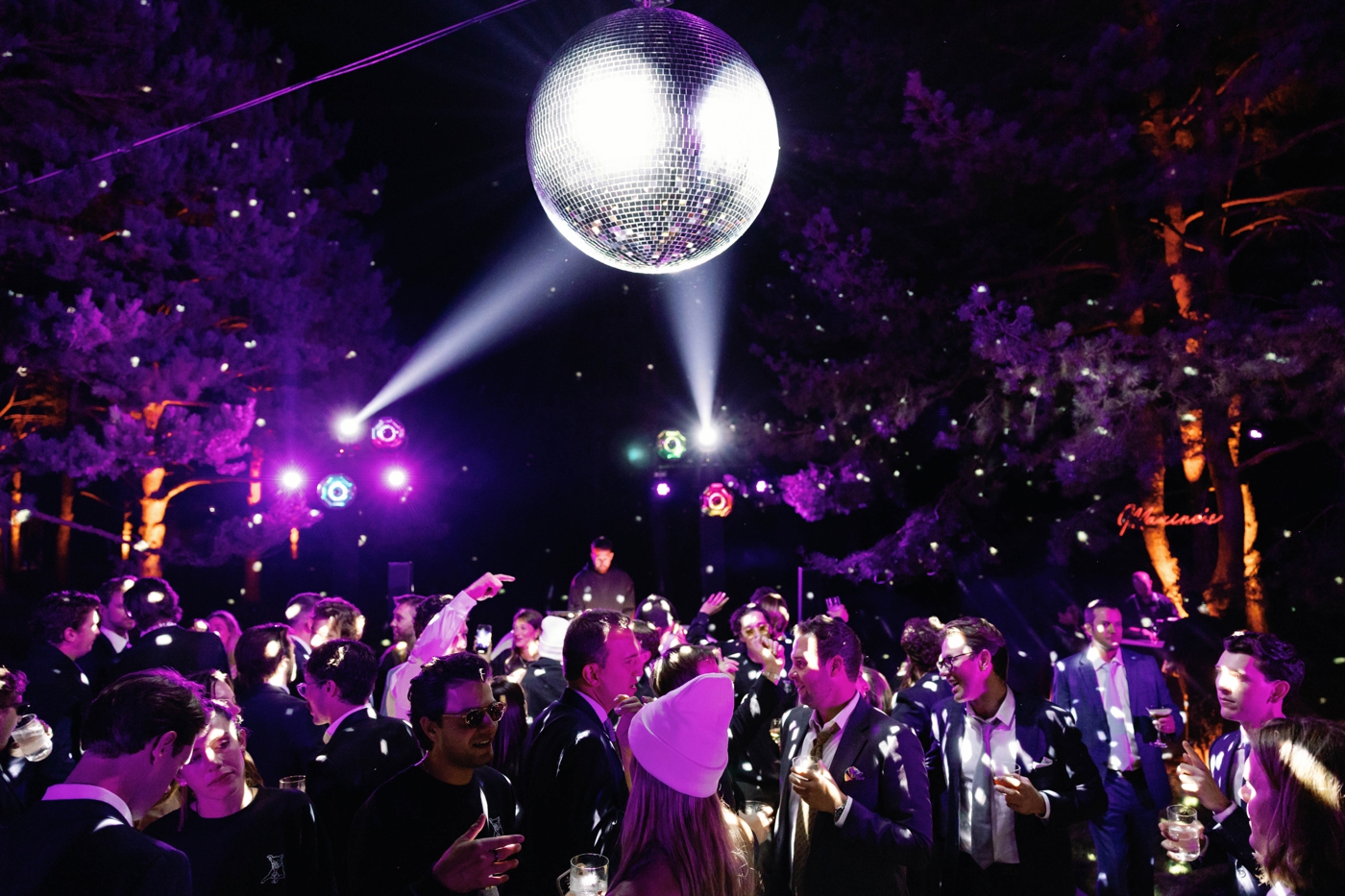 A giant disco ball over a packed dance floor for a destination wedding in Upstate New York