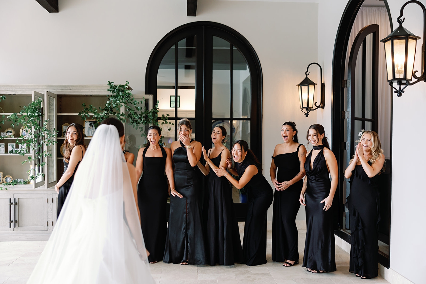 Bridesmaids seeing a bride for the first time in her Mark Ingram ball gown and long cathedral veil