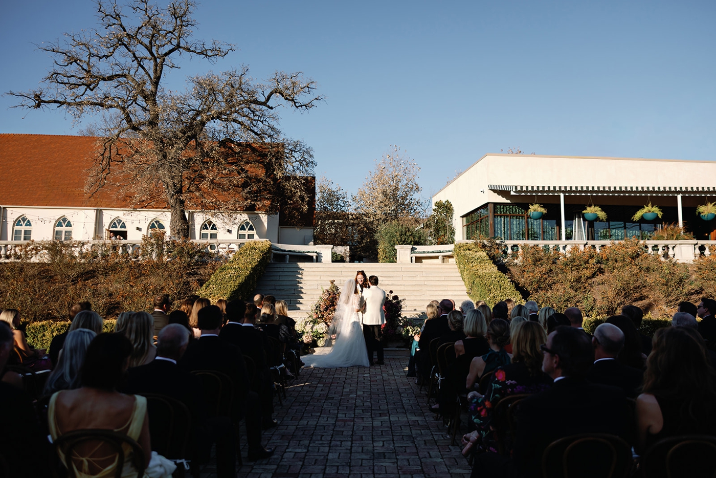 A bride and groom at the alter at Commodore Perry Estate, sharing a first kiss